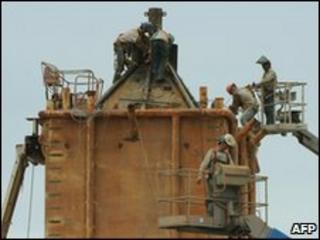 Welders at work on a Pollution Control Dome