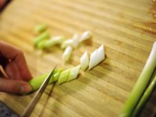 Spring onion being chopped, BBC