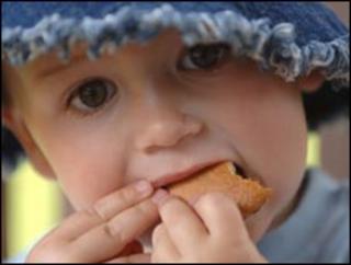 Toddler eating biscuit