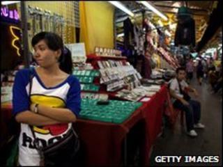 Thai woman waits for business at a stall