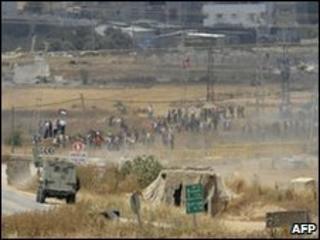 Israeli troops stand guard on the Israeli side of the border with the Gaza Strip, April 2010