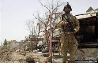 Iraqi soldier stands guard at bombed market in Khalis, 22/5/10