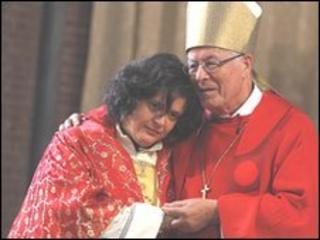 Maria Vittoria Longhitano (l) is embraced by Bishop Fritz-Rene Muller during a mass in which she was ordained