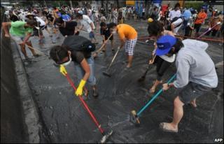 People cleaning the streets