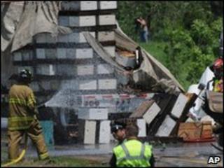 Firemen hose down bee hives spilled from lorry in Lakeville, Minnesota - 24 May 2010