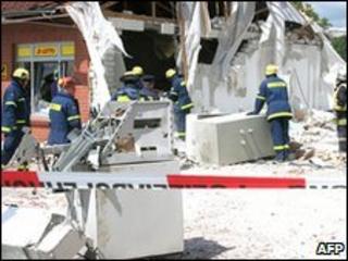 The fire brigade clear up at the site of a bank that was blown up in Malliss, northern Germany, 26 May 2010