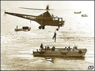 A US Marine helicopter picks up personnel from a landing barge in Inchon Harbour