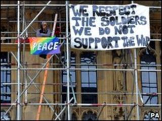 A protester on the scaffolding outside Parliament