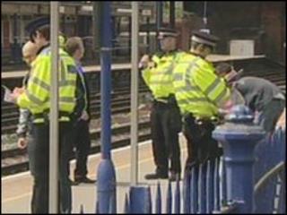 Police at Fleet railway station on Thursday