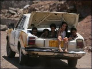 Children sit in the boot of a car in Yemen