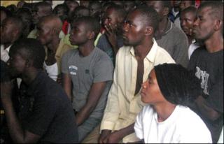 Fans watch an English Premier League football match in Kibera slum in Nairobi