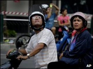 A couple look up at the ruins of Bangkok's Central World Plaza shopping mall on 22 May 2010