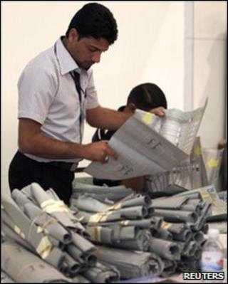 An official from Iraq's Independent High Electoral Commission takes part in a recount of parliamentary election ballots in Baghdad on 14 May 2010