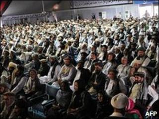 Delegates look on as Afghan President Hamid Karzai delivers a speech at the "peace jirga"