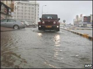 A car drives through flooded streets in Muscat, Oman 4 June