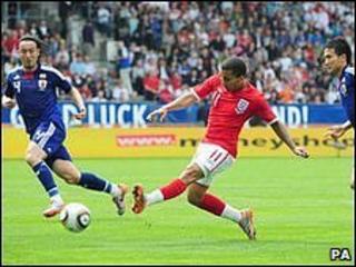 Aaron Lennon shoots for England against Japan in a pre-World Cup friendly