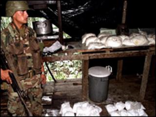 A soldier guards cocaine in a drug lab in Colombia