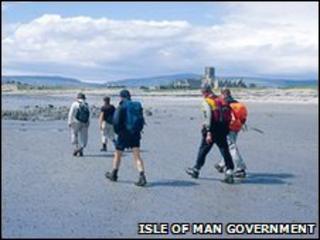 Walkers on Castletown beach
