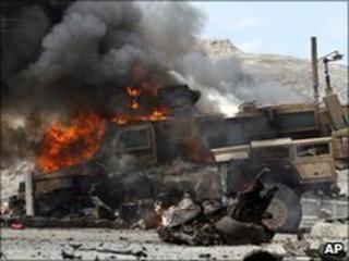 A Nato vehicle burns after a militant attack in Jalalabad, Afghanistan, 6 June 2010