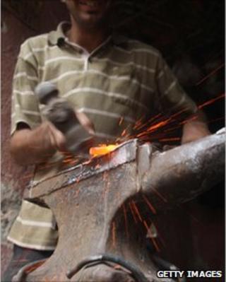 Blacksmith working in a forge