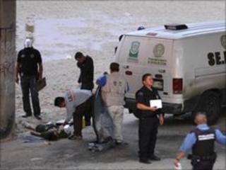 Mexican police stand near the body of Sergio Adrian Hernandez