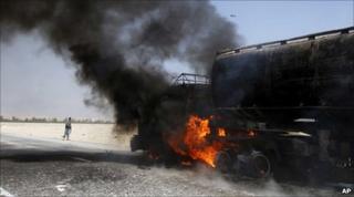 A Nato fuel tanker burns after a roadside bomb attack east of Kabul, 11 June