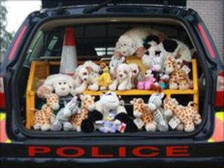 Toys in back of a police vehicle