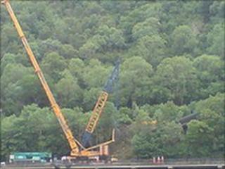 Crane removing derailed train