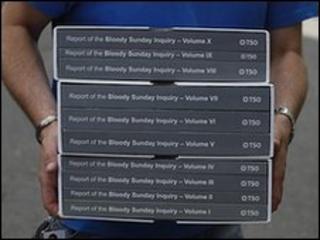 A person carries a copy of the Saville Inquiry report