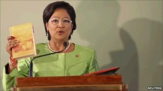 Ms Persad-Bissessar holds the Gita as she takes the oath of office in Port of Spain 27/05/2010