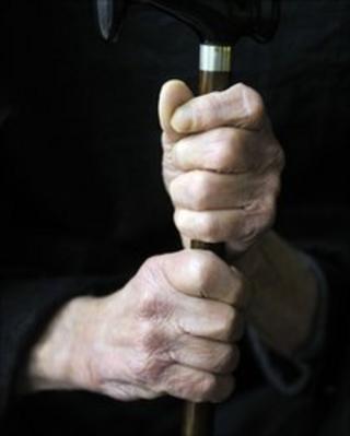 Older man holding a walking stick