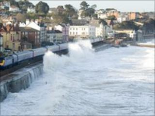 Waves breaking over rail line at Dawlish