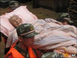 soldiers help a woman trapped by the flooding in Qingliu County, south-east China's Fujian Province