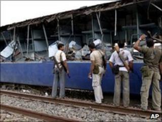 police walk past remains of shattered carriage