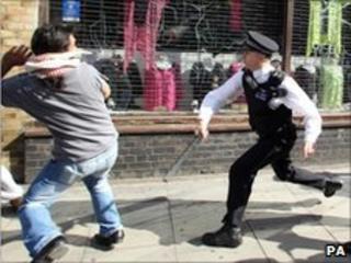 A policeman confronts a man
