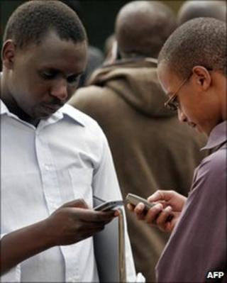 Kenyan men with mobile phones