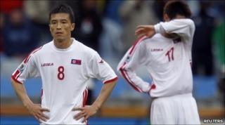 North Korea's Ji Yun-nam (L) and An Yong-hak at the final whistle