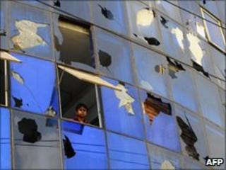 Worker looks out of a window of a garment factory in Ashulia