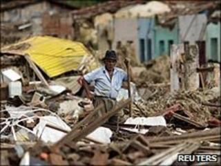 Man stands near destroyed house in Palmares city, Alagoas, Brazil, on 23/6/2010
