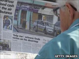 A woman reading a newspaper