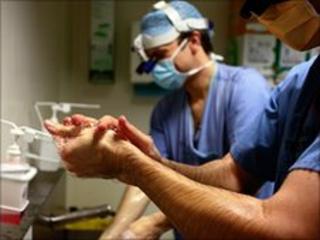 Surgeons scrub up before an operation in an NHS hospital