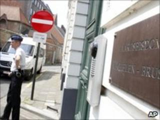 Police officer outside the Archdiocese of Mechelen, Belgium on 24 June