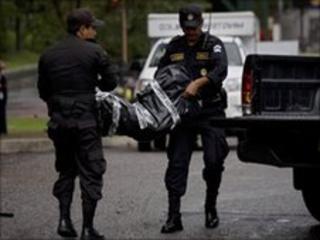 Police carrying the body of the victim