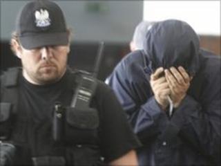 Uri Brodsky (right) was brought to court under heavy security 5 July 2010
