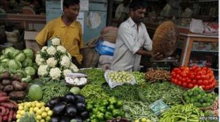 A vendor sells vegetables at a market in Mumbai June 14, 2010