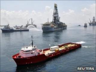 Ships and drilling rigs surround the Discoverer Enterprise