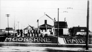 Moonshine barrels line a road in 1925