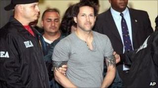 Jose Figueroa Agosto is escorted by US agents in San Juan. Photo: 17 July 2010
