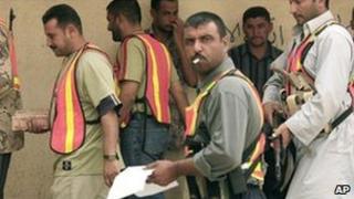 Members of the Awakening Council in Arab Jabour, near Baghdad, receive their pay (image from October 2007)