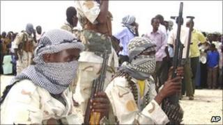 Al-Shabab fighters provide security during a demonstration in Suqa Holaha neighbourhood in Mogadishu, Somalia, Monday, July 5, 2010